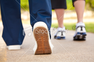 stock-photo-16288424-closeup-of-walker-s-shoes-on-a-pathway